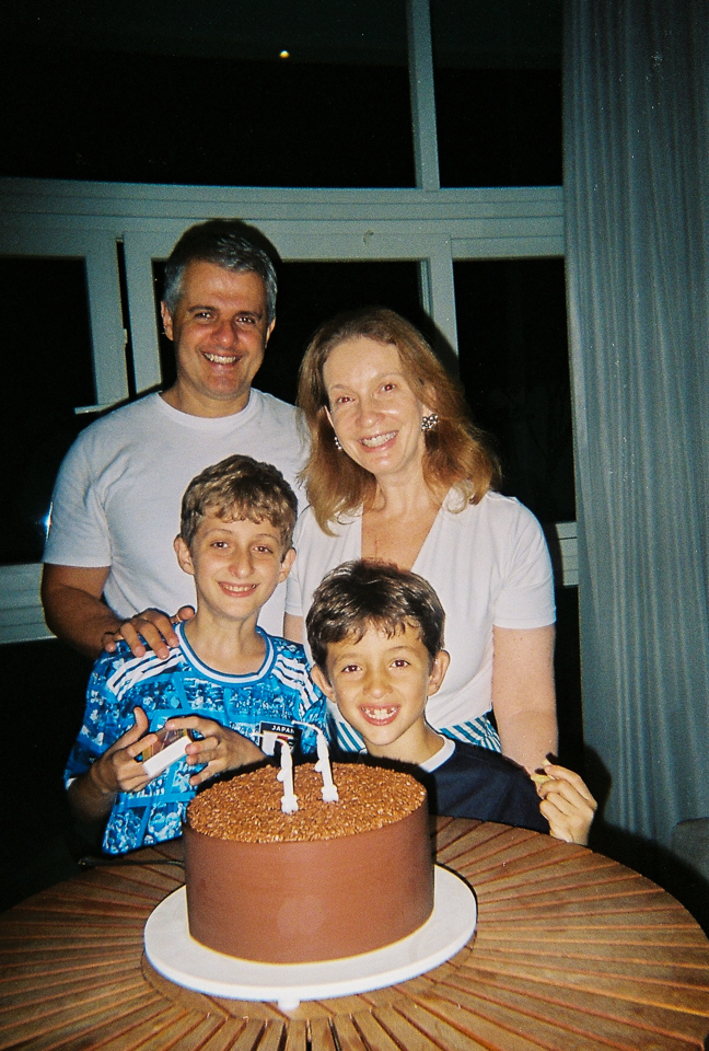 Família reunida ao redor do bolo de aniversário